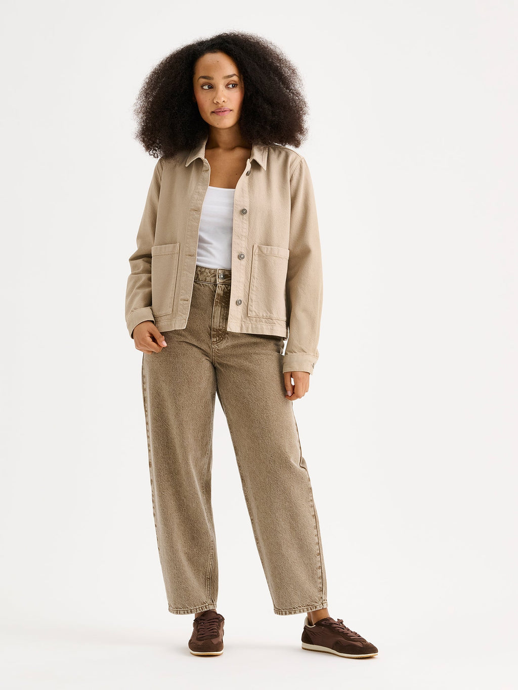Nanso women's relaxed short MIMI jacket in a beautiful brown shade on a model with brown jeans.
