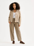 Nanso women's relaxed short MIMI jacket in a beautiful brown shade on a model with brown jeans.