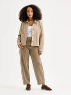 Nanso women's relaxed short MIMI jacket in a beautiful brown shade on a model with brown jeans.